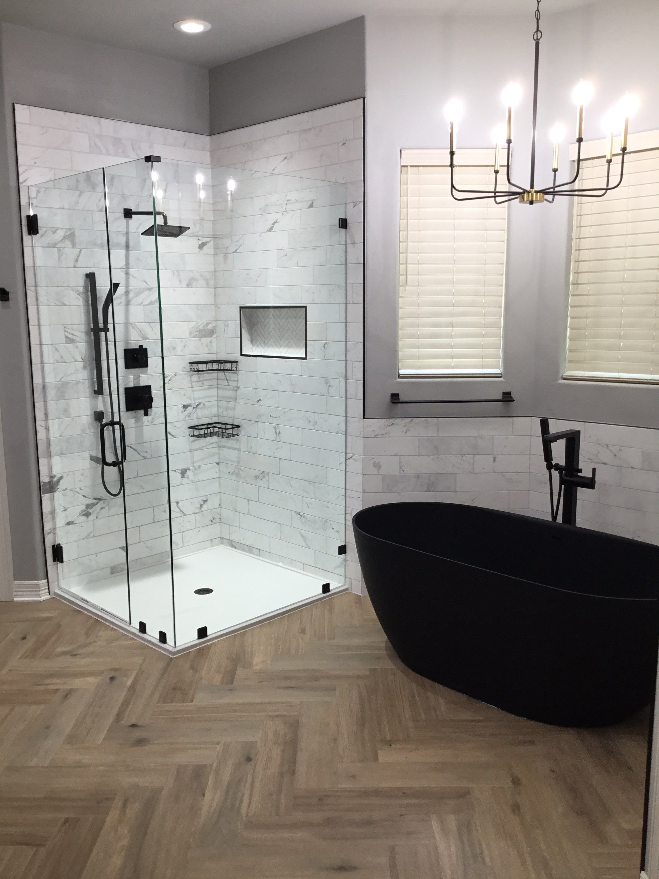 modern san antonio bathroom renovation with chevron wood floors