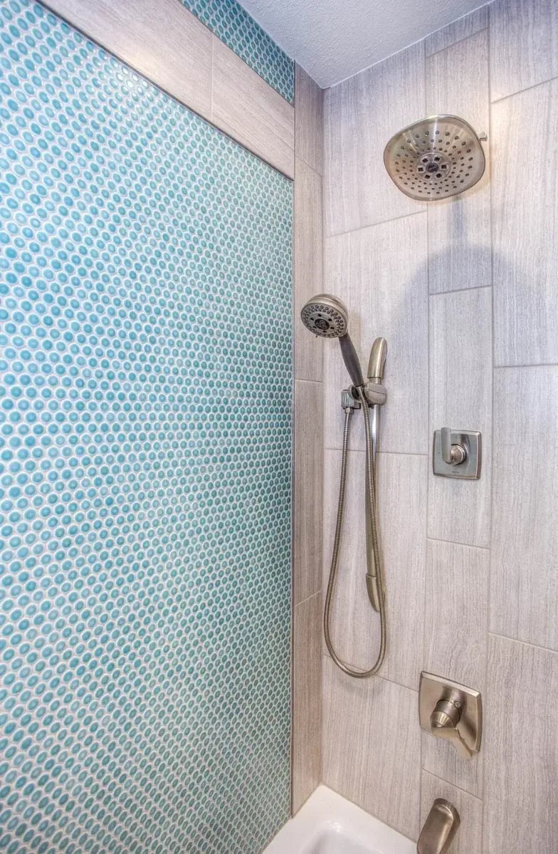 Inside a Shower With Blue Dotted Backsplash